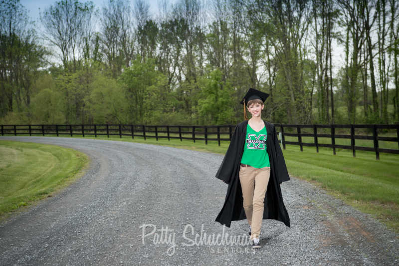senior girl black cap and gown outdoors in road