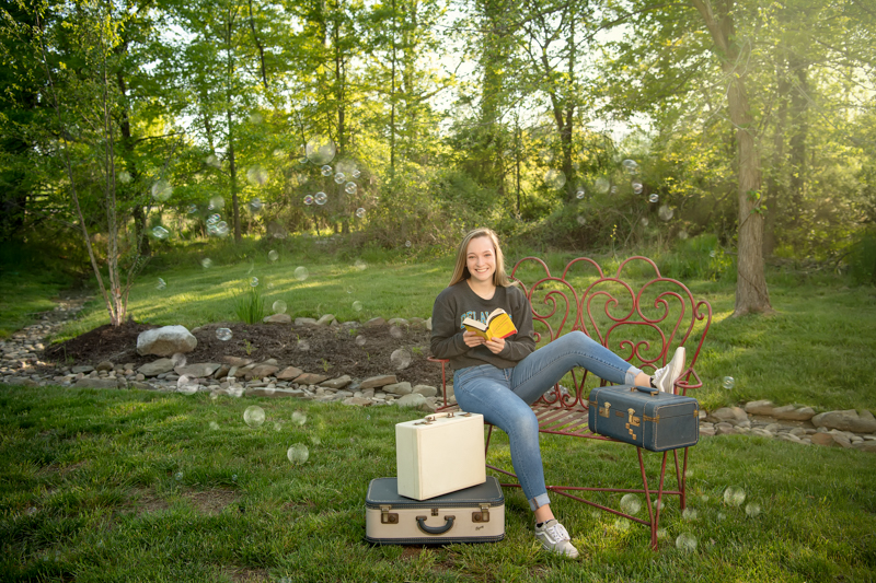 Socially distant senior photos with books and bubbles