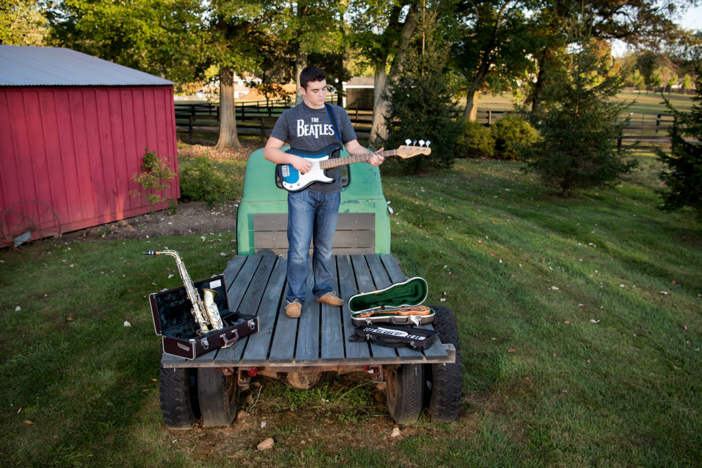 senior boy outdoors multiple instruments