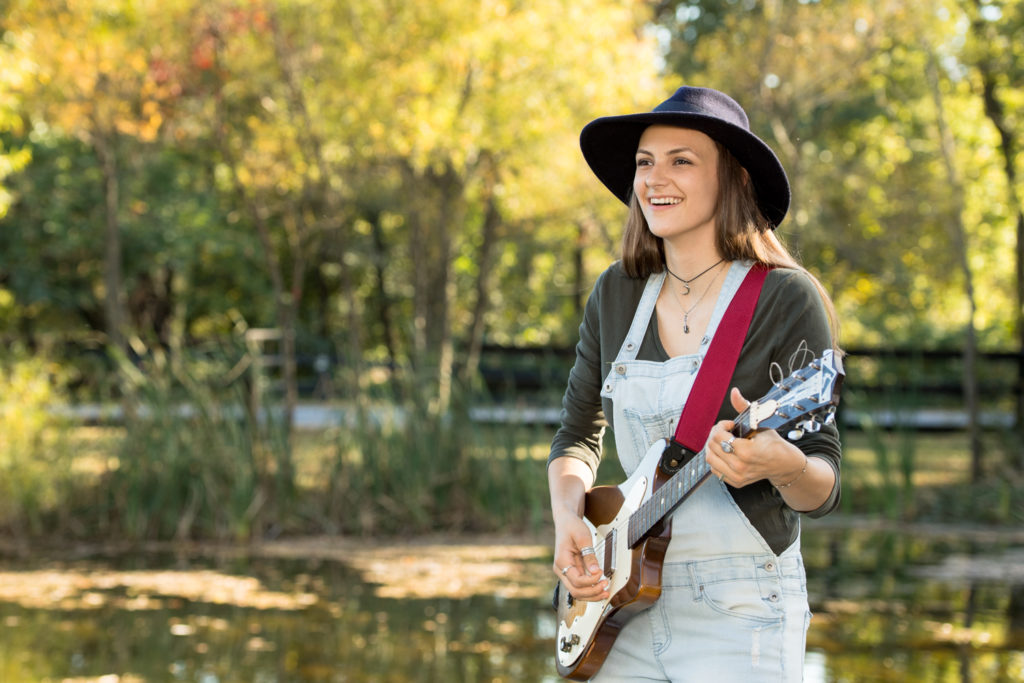 senior portrait girl with guitar outdoors