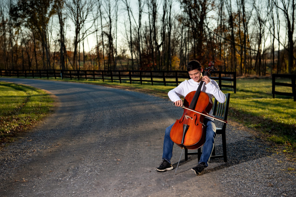 senior boy in road with cello